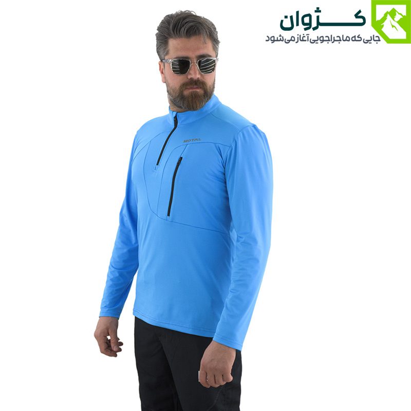 مدل مردانه با بلوز ترکینگ آبی رنگ موتال، ایستاده به صورت مورب مقابل زمینه سفید